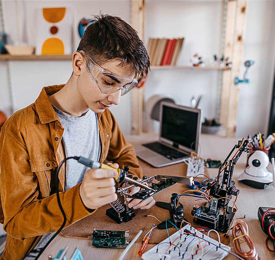 Student soldering electronics