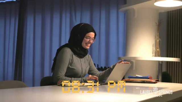 female student smiling while typing