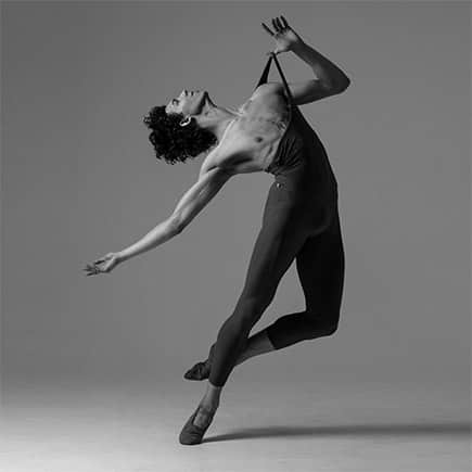 Performer at Boston Ballet, Daniel Rubin, dancing in black and white color.