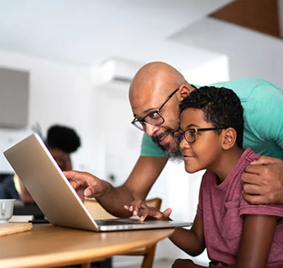 dad showing daughter something on the laptop