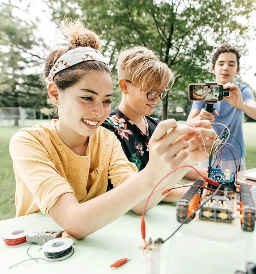 Students learning robotics outside