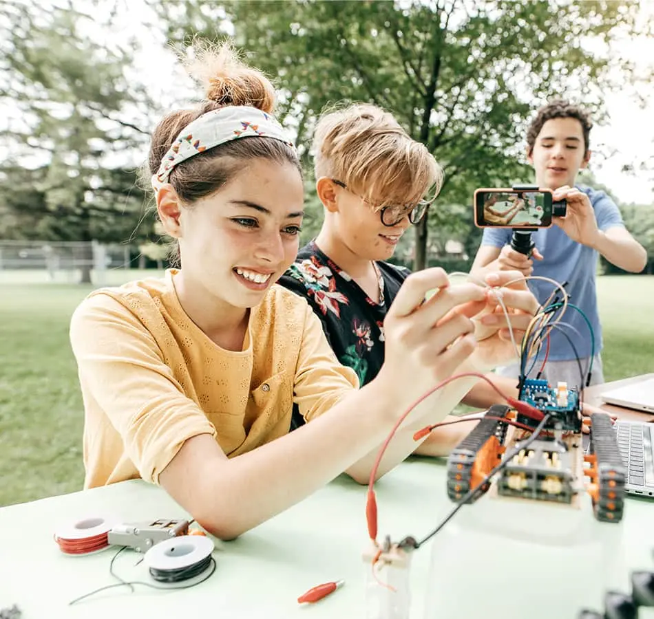 Students learning robotics outside