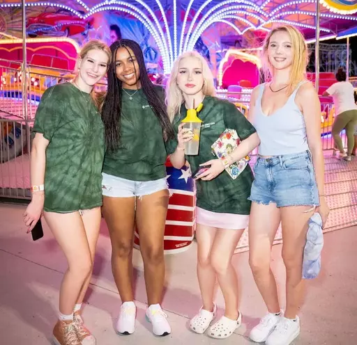 4 female students at a carnival