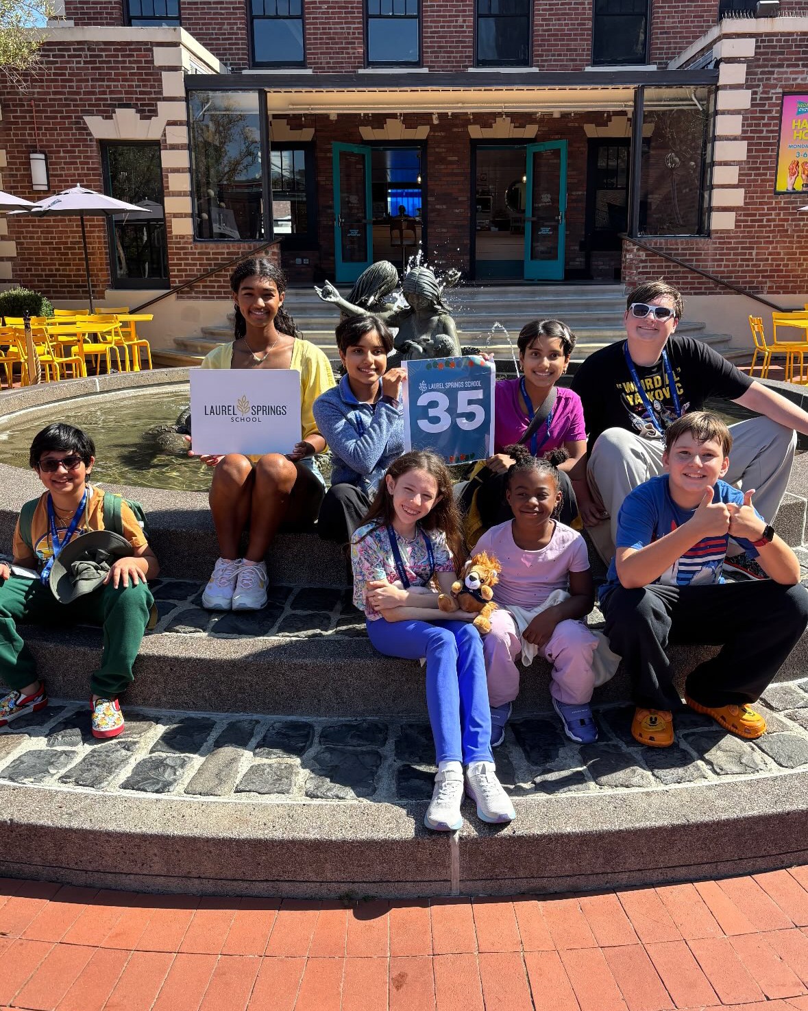 Laurel springs students sitting on stoop and holding signs